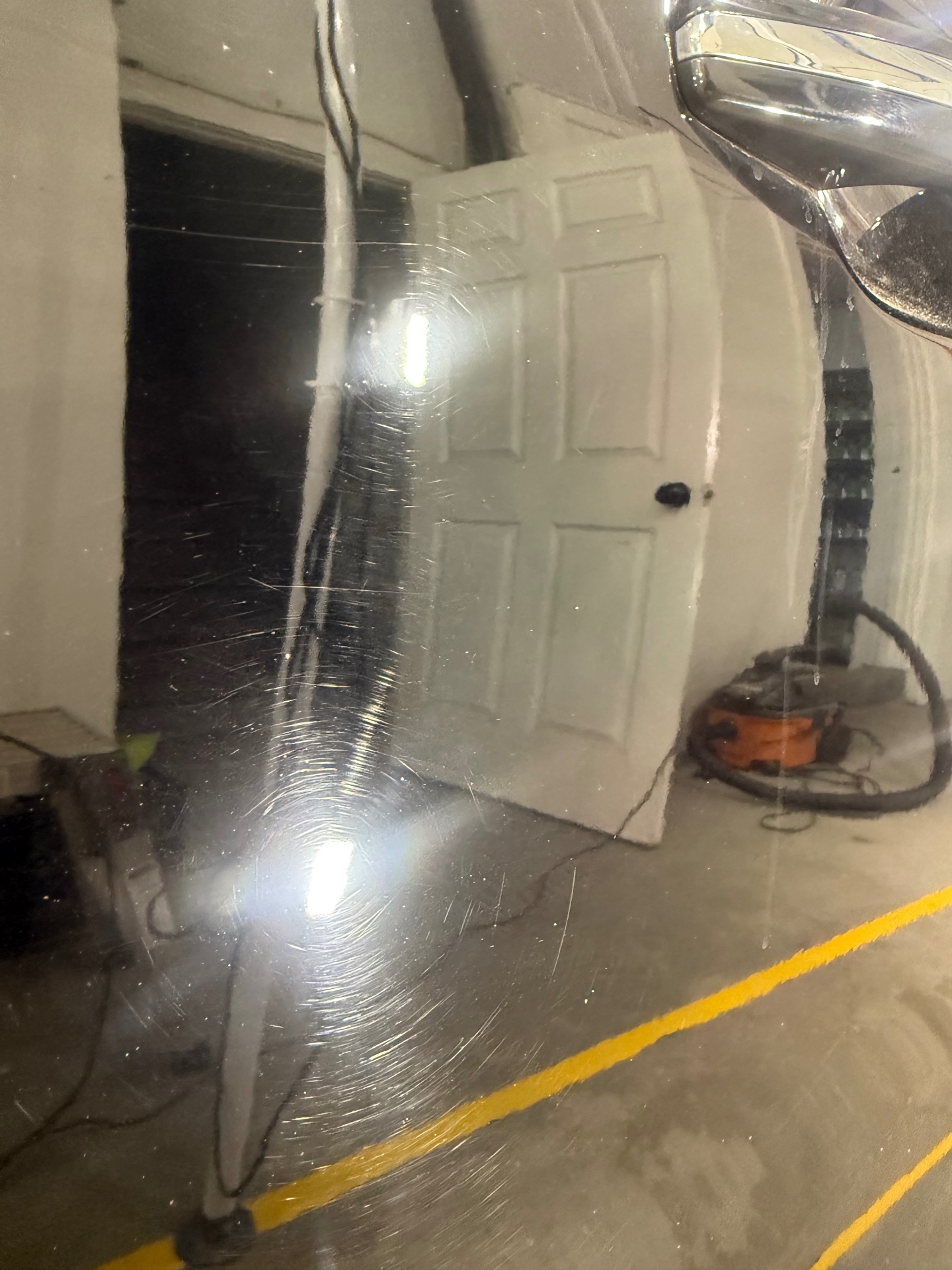 Glossy black panel after machine polish revealing crisp reflections